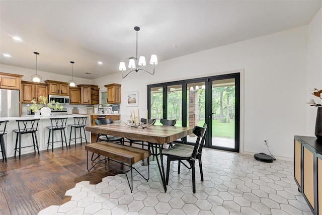 dining room with recessed lighting, baseboards, a notable chandelier, and tile patterned floors