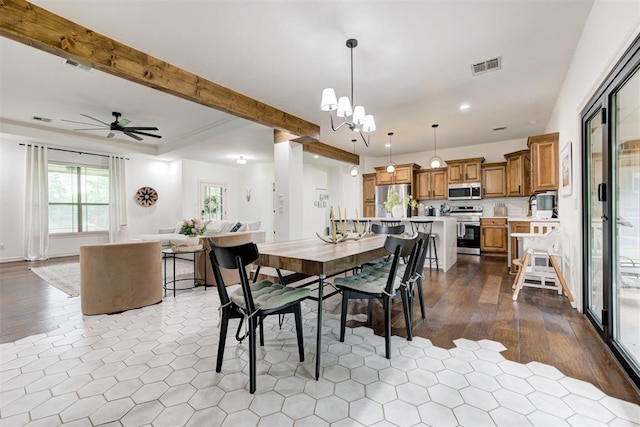 dining space with ceiling fan with notable chandelier, recessed lighting, and visible vents
