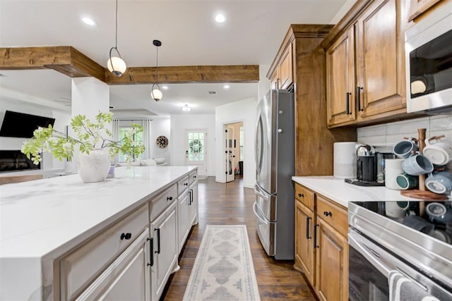 kitchen featuring open floor plan, dark wood-type flooring, brown cabinets, tasteful backsplash, and appliances with stainless steel finishes
