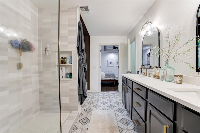 ensuite bathroom with walk in shower, a sink, double vanity, ensuite bathroom, and visible vents