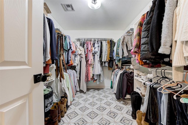 spacious closet with visible vents and light floors