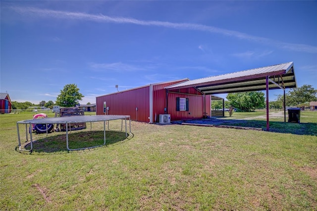 exterior space with a lawn and a carport