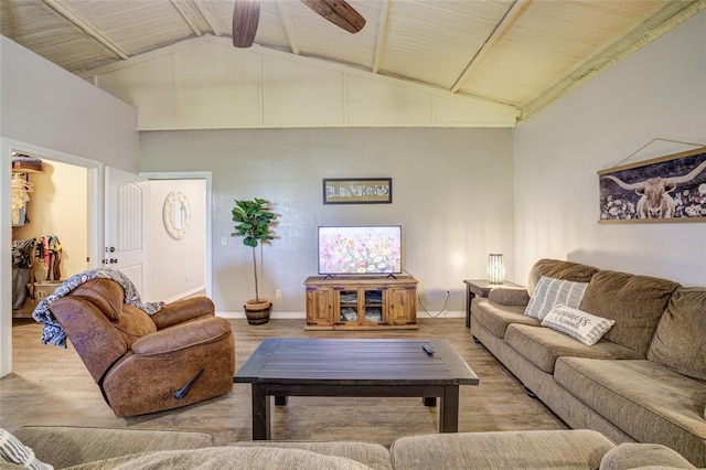 living area featuring baseboards, ceiling fan, wood finished floors, and high vaulted ceiling