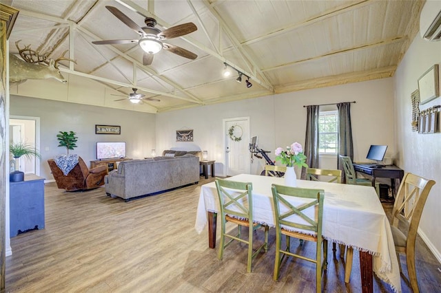 dining space featuring wood ceiling, ceiling fan, a wall mounted air conditioner, wood finished floors, and vaulted ceiling with beams