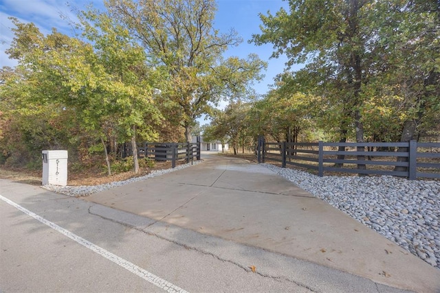 view of street with concrete driveway