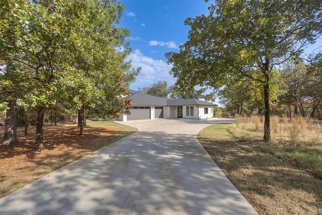 view of front of home with a garage and concrete driveway