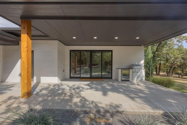 view of patio with a grill, french doors, and a carport