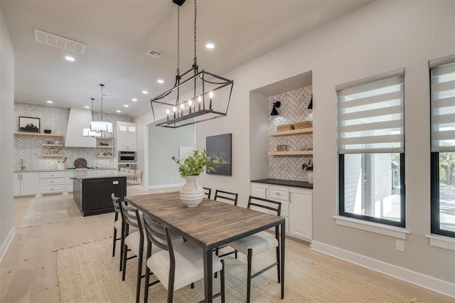 dining space with visible vents, recessed lighting, and light wood finished floors