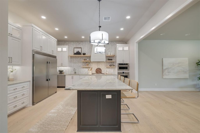 kitchen featuring open shelves, appliances with stainless steel finishes, white cabinetry, backsplash, and visible vents