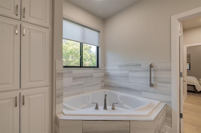 ensuite bathroom with connected bathroom and a garden tub