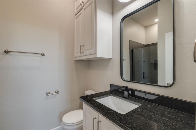 full bath featuring vanity, a shower stall, and toilet