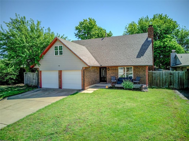 view of front of house with brick siding, a front lawn, fence, and driveway