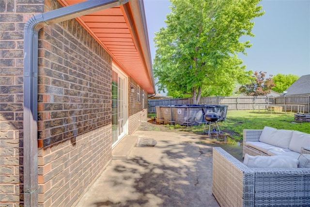 view of patio / terrace featuring a fenced in pool, a fenced backyard, and an outdoor hangout area