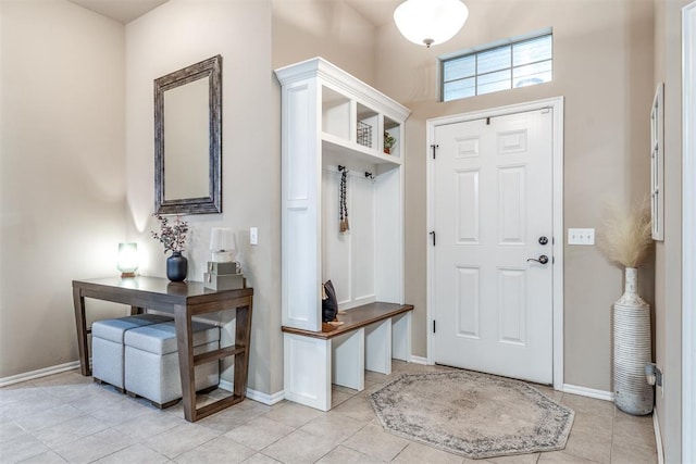 mudroom featuring light tile patterned flooring and baseboards