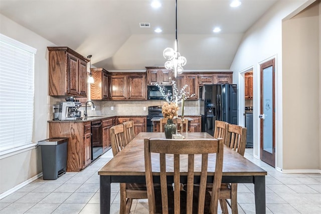 dining room with visible vents, light tile patterned floors, and lofted ceiling
