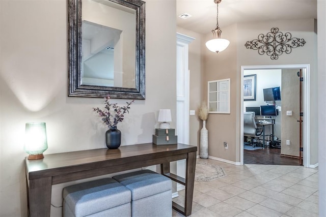 interior space with visible vents, baseboards, and light tile patterned floors