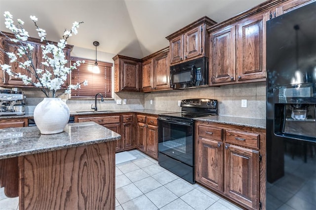 kitchen featuring decorative backsplash, vaulted ceiling, a sink, black appliances, and light tile patterned flooring