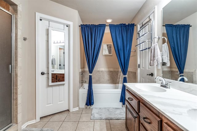 full bathroom featuring tile patterned floors, a shower stall, a tub to relax in, and vanity