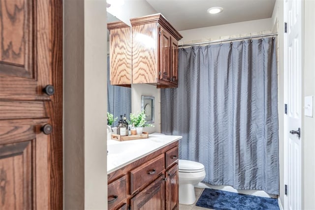 bathroom with vanity, toilet, and curtained shower