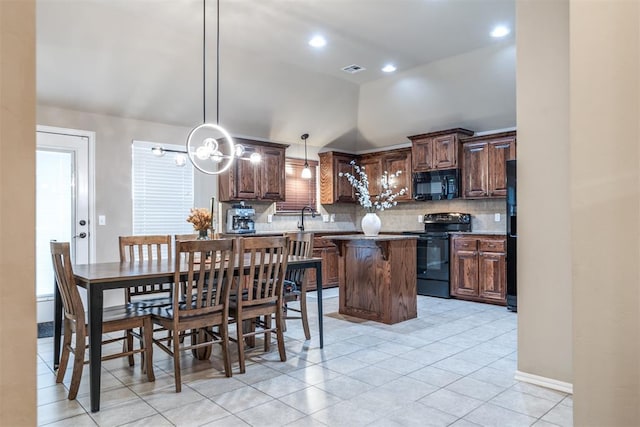 interior space featuring light tile patterned flooring, black appliances, vaulted ceiling, and tasteful backsplash