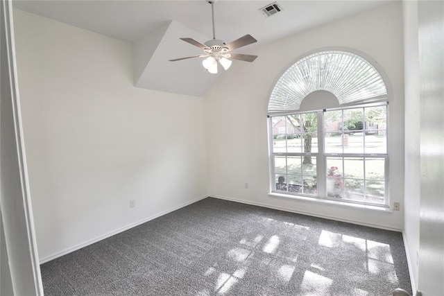 carpeted empty room featuring baseboards, ceiling fan, and visible vents