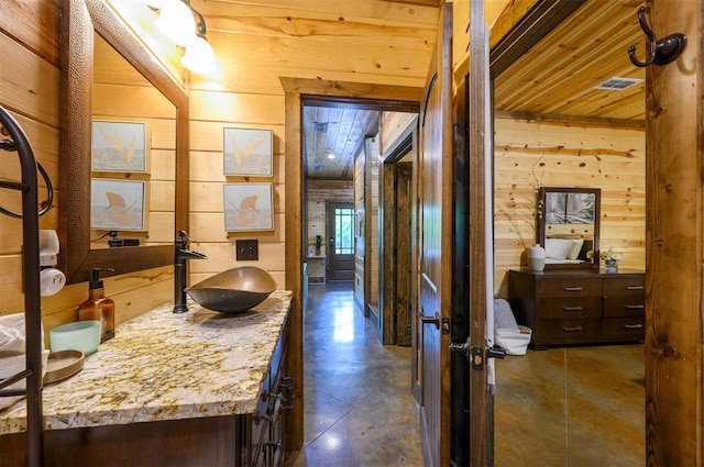 678 N State Highway 259a, Broken Bow, OK 74728 - hallway with wooden walls, wooden ceiling, finished concrete flooring, and a sink