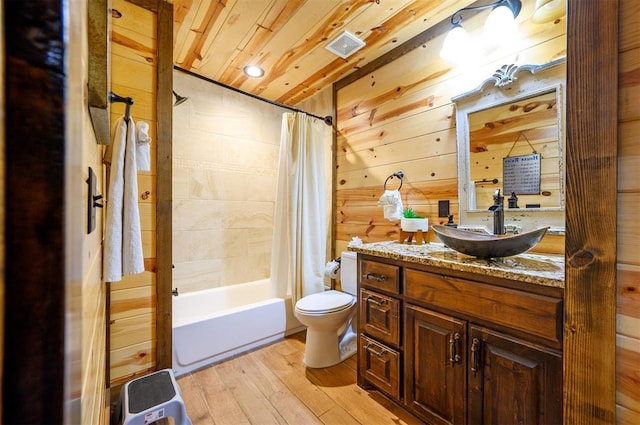 678 N State Highway 259a, Broken Bow, OK 74728 - bathroom featuring vanity, wood-type flooring, toilet, shower / tub combo with curtain, and visible vents