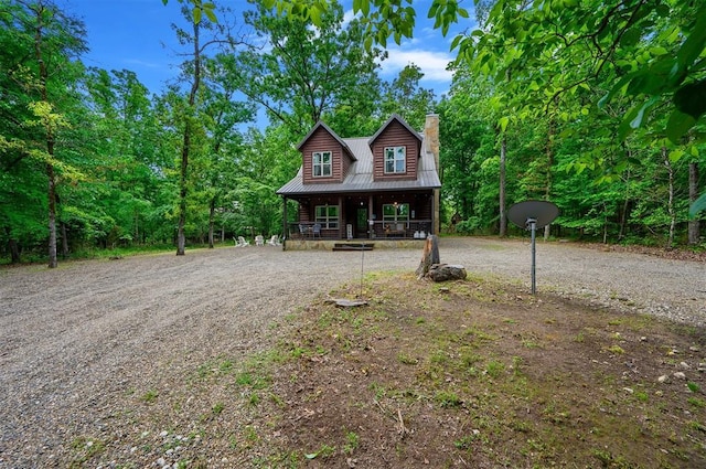 678 N State Highway 259a, Broken Bow, OK 74728 - chalet / cabin featuring covered porch, a chimney, and metal roof