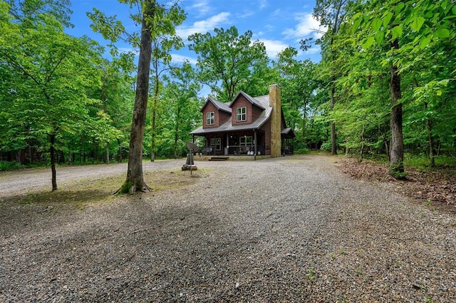 678 N State Highway 259a, Broken Bow, OK 74728 - chalet / cabin featuring curved driveway, a chimney, and a porch