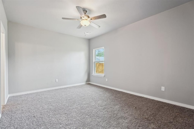 carpeted empty room featuring baseboards, a ceiling fan, and visible vents