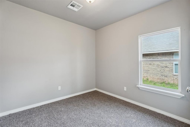 carpeted empty room with baseboards and visible vents
