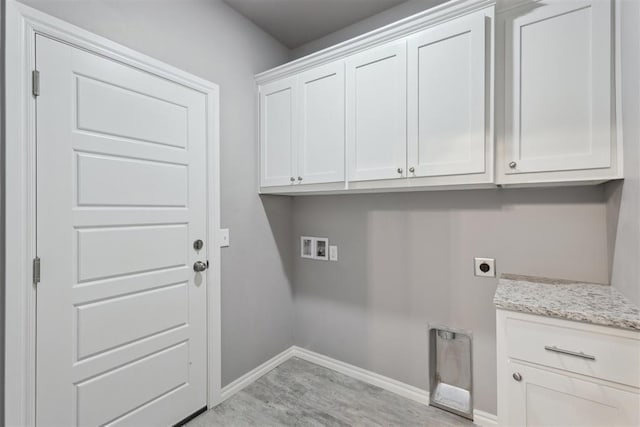 clothes washing area with baseboards, hookup for an electric dryer, cabinet space, and hookup for a washing machine
