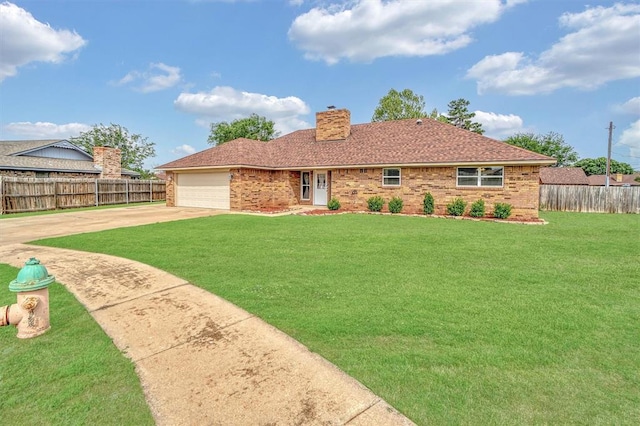 rear view of property featuring fence, a yard, and concrete driveway