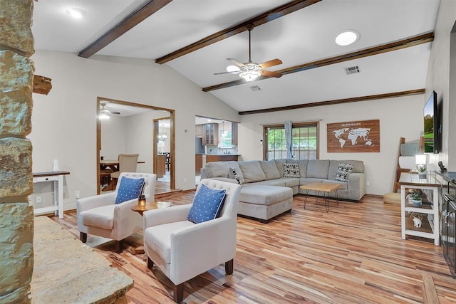 living area with a ceiling fan, visible vents, vaulted ceiling with beams, and light wood-style flooring