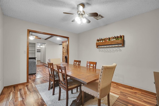 dining space featuring a ceiling fan, wood finished floors, and visible vents