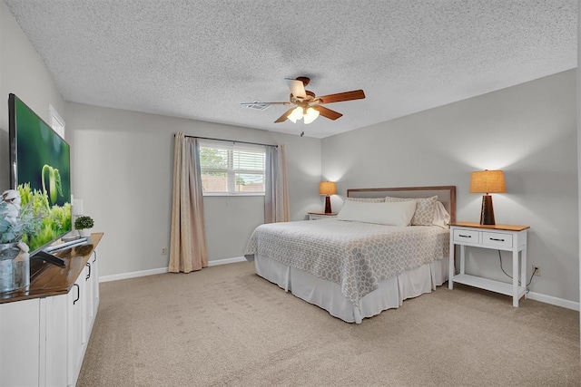 bedroom featuring baseboards, light carpet, and a textured ceiling