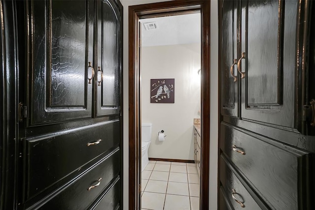 interior space with baseboards, visible vents, and light tile patterned floors