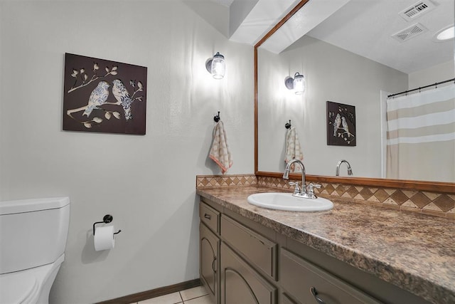 full bathroom featuring vanity, toilet, tile patterned floors, tasteful backsplash, and visible vents