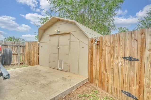 view of shed featuring fence