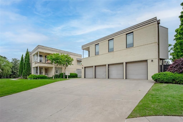1000 NW 37th St Unit 1000 & 1002, Oklahoma City, OK 73118 - view of front facade with brick siding, an attached garage, driveway, and a front yard