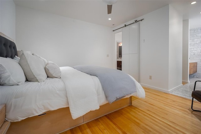 1000 NW 37th St Unit 1000 & 1002, Oklahoma City, OK 73118 - bedroom with recessed lighting, a barn door, light wood-style flooring, and ensuite bath