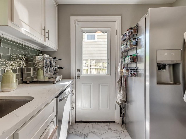 entryway featuring marble finish floor