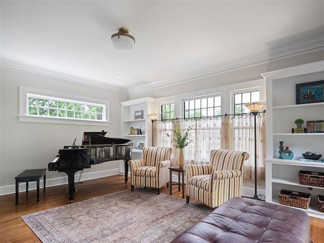 sitting room with crown molding and wood finished floors
