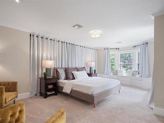carpeted bedroom featuring baseboards, visible vents, and ornamental molding