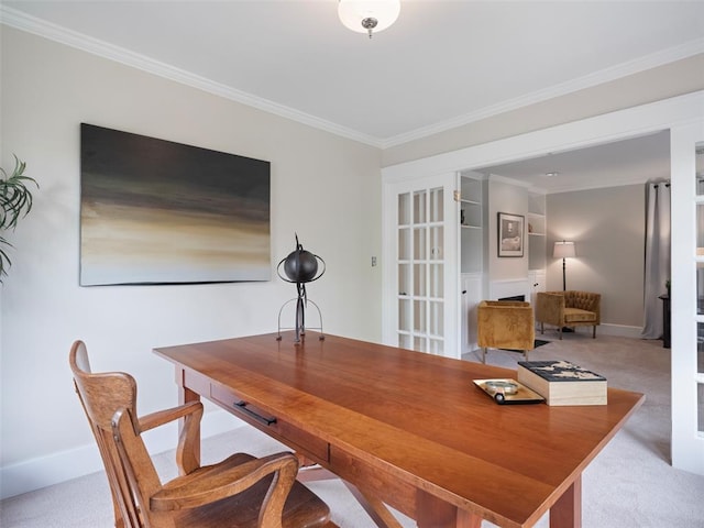 carpeted office space featuring crown molding and baseboards