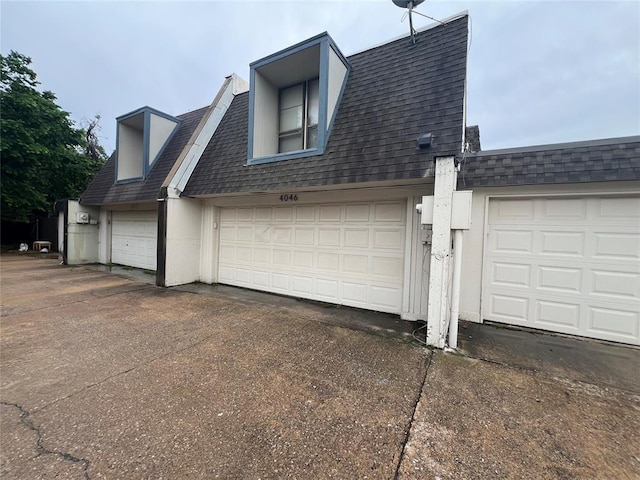 view of side of property featuring roof with shingles