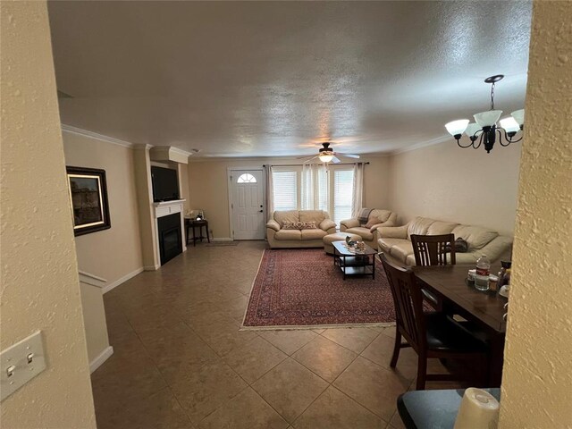 living room featuring tile patterned flooring, ornamental molding, and a glass covered fireplace