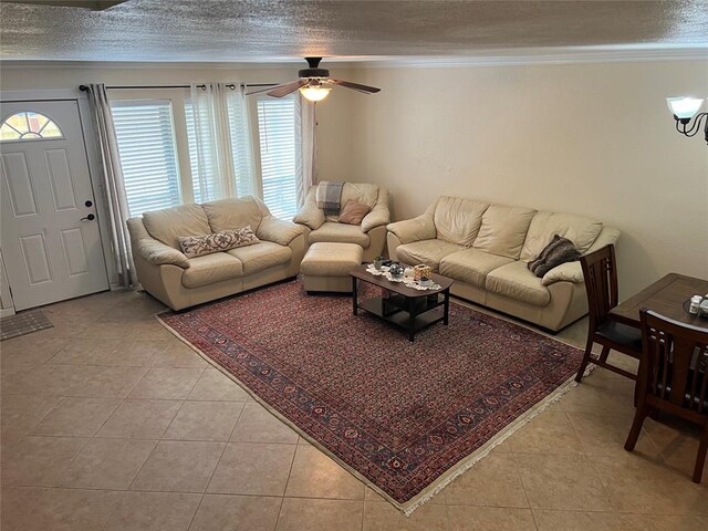 living area with crown molding, light tile patterned flooring, a ceiling fan, and a textured ceiling