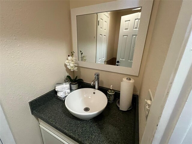 bathroom with a sink and a textured wall