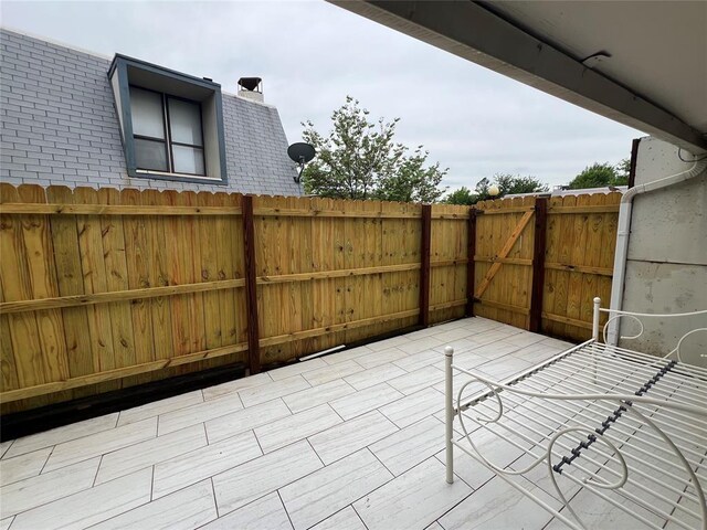 view of patio featuring fence